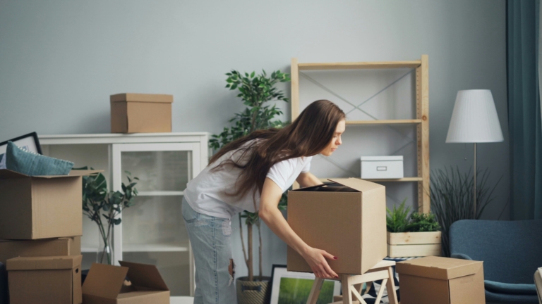 Packing household belongings into moving boxes